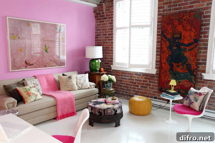 Pops of pink in the eclectic living room with lovely brick wall and colorful wall art