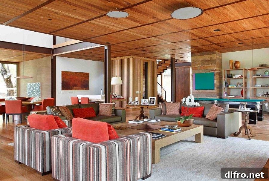 Cushions and accent pillows bring color to the spacious living room in wood and white