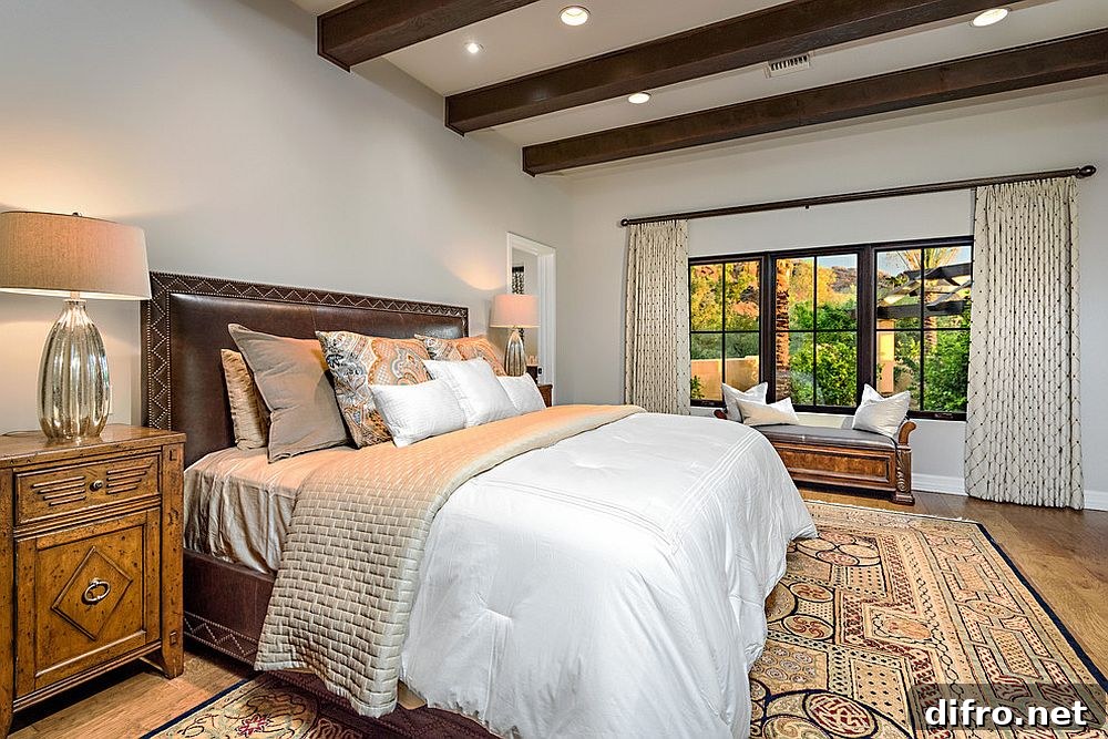 Mediterranean style bedroom with dark wooden ceiling beams