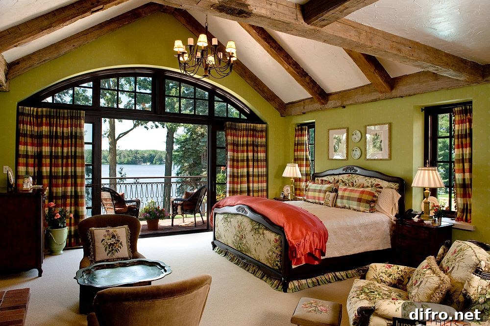 Spacious Mediterranean bedroom in green with wooden beams