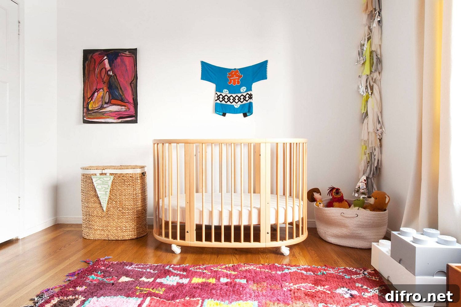 Small white crib on wheels