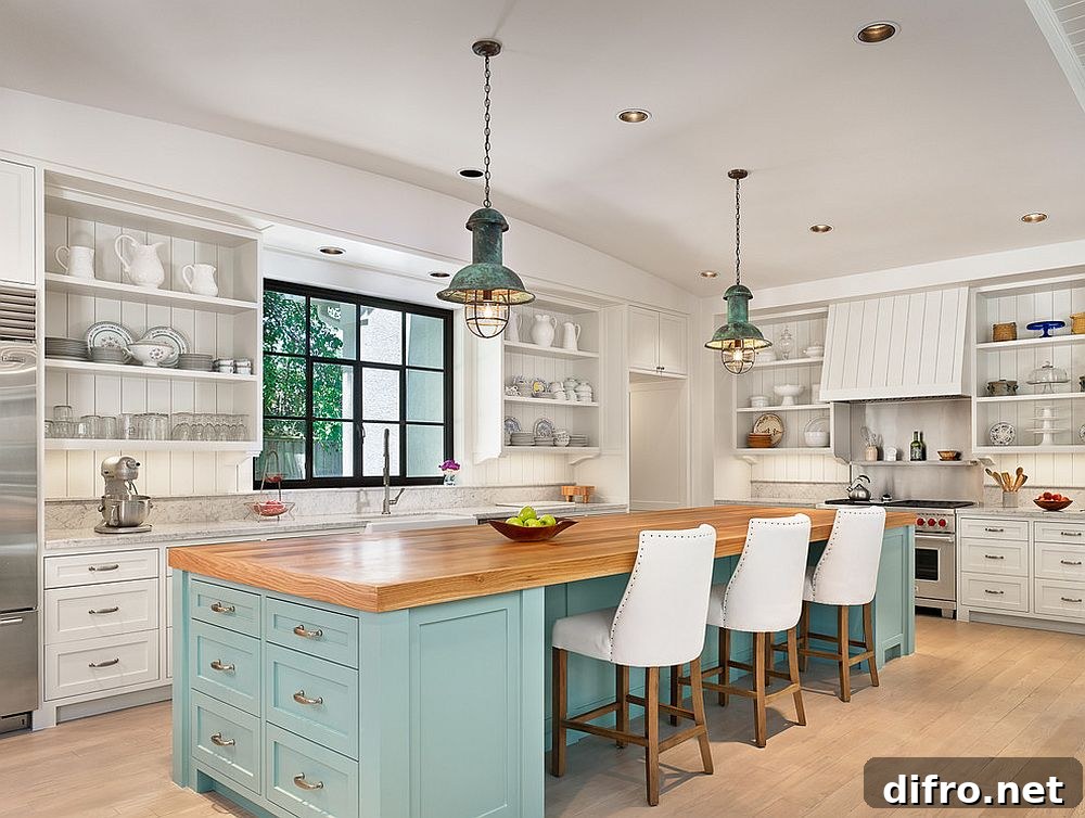Blue island in white beach-style kitchen
