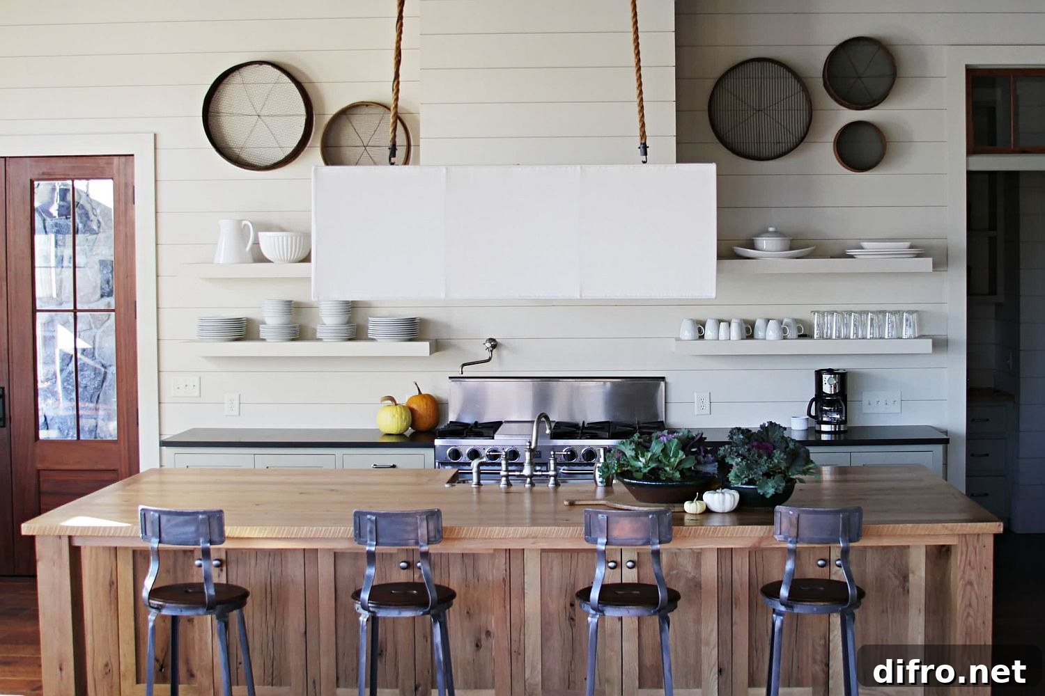 Modern kitchen with white backdrop and wooden island