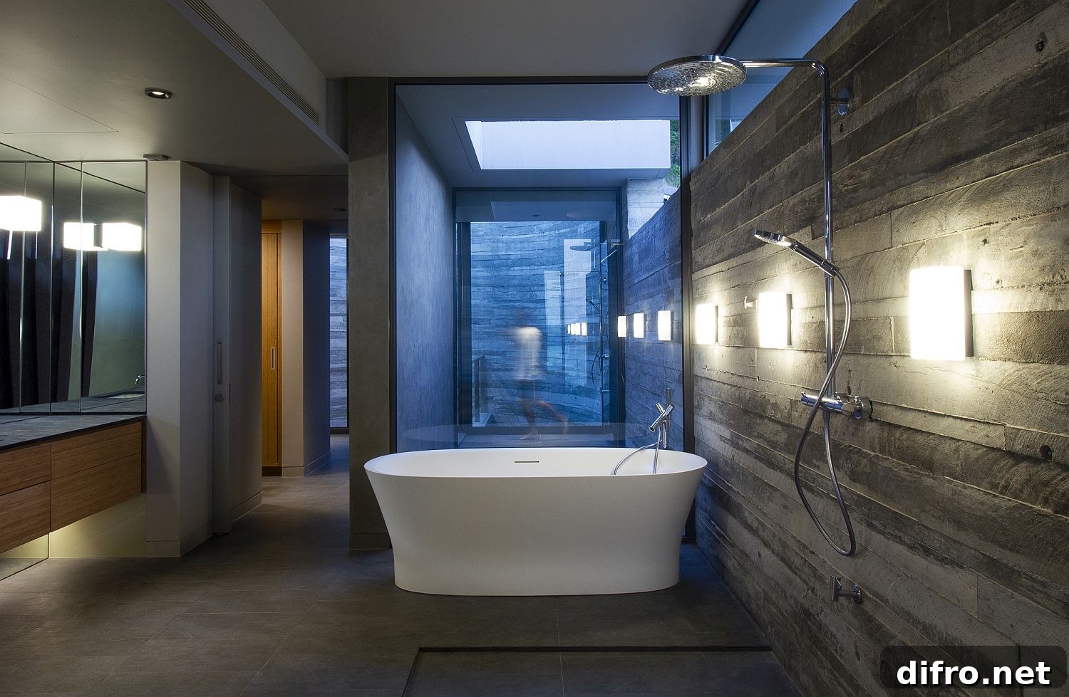 Freestanding bathtub in concrete bathroom