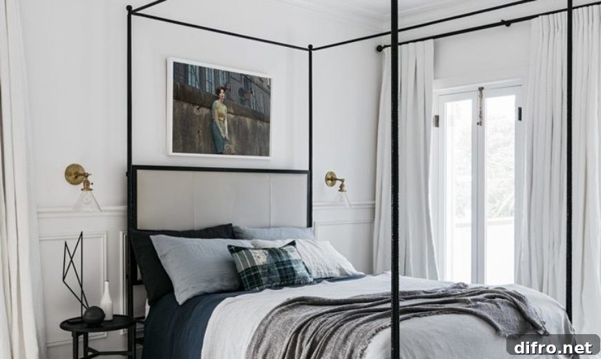 Minimalist canopy bed in a monochromatic room
