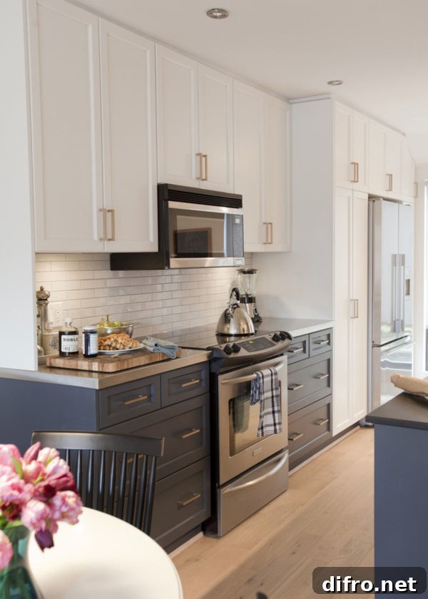 Traditional galley kitchen with deep blue base cabinets and tall storage to the ceiling