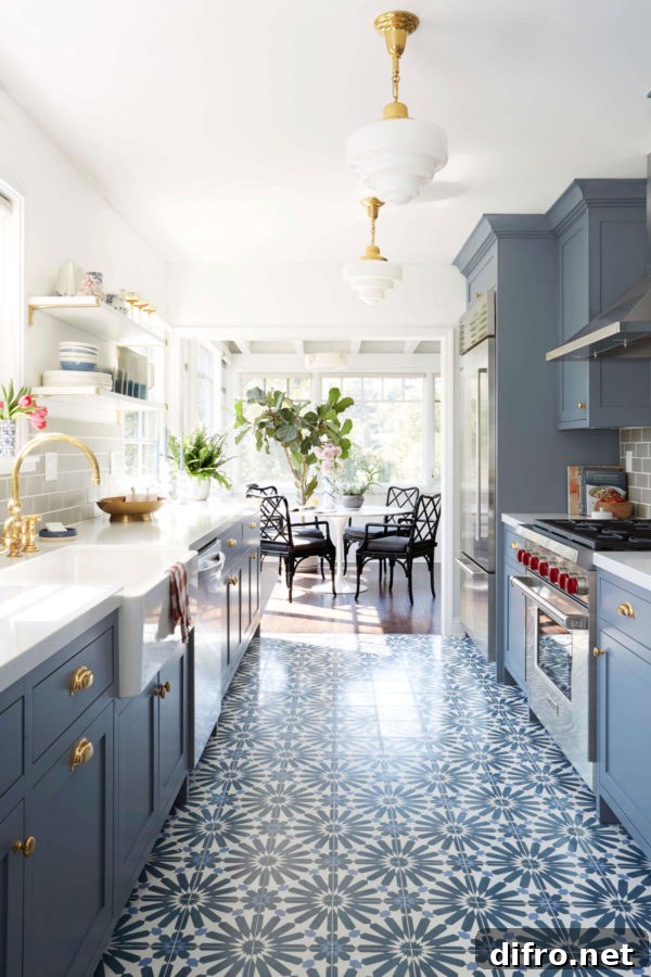 Patterned floor in an asymmetrical galley kitchen with blue cabinets and retro stove