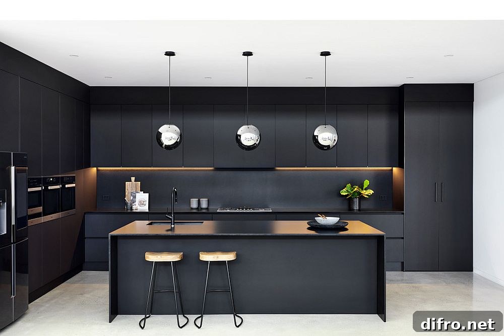 Stainless steel pendants in a black kitchen