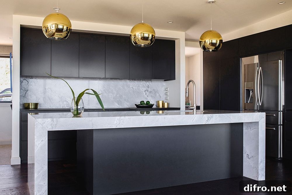 Metallic pendant lights over black kitchen