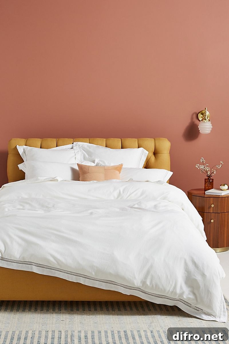 Earthy pink walls with mustard bed and wooden accents