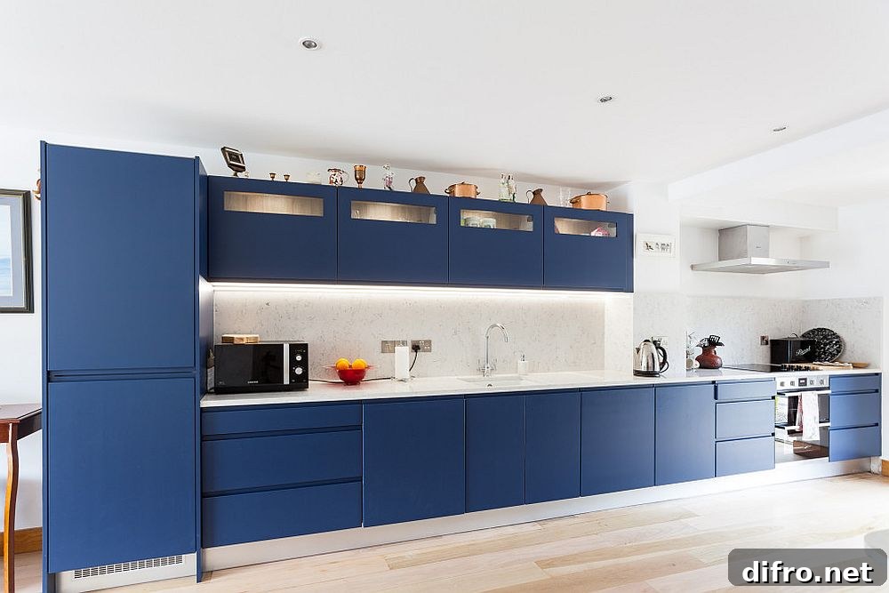 Sleek single-wall kitchen in deep blue and white
