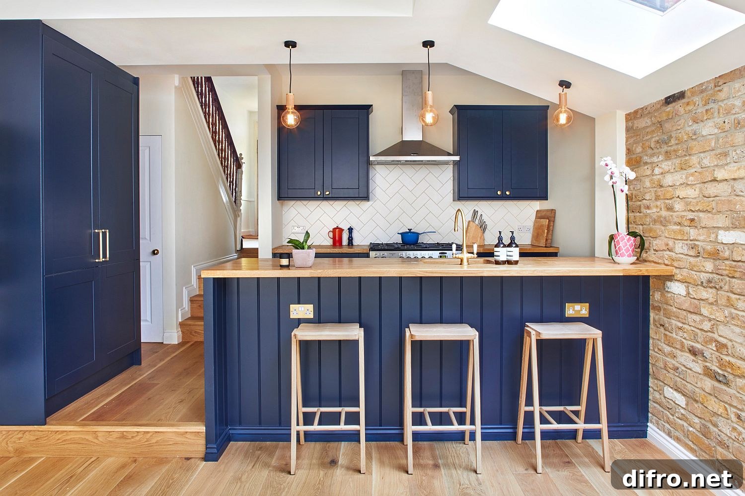Modern kitchen with brick wall, skylight and blue accents