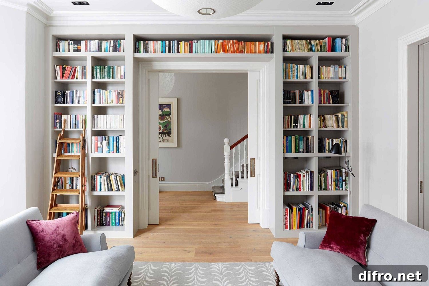 Bookshelf wrapping around a doorway in a bright living room