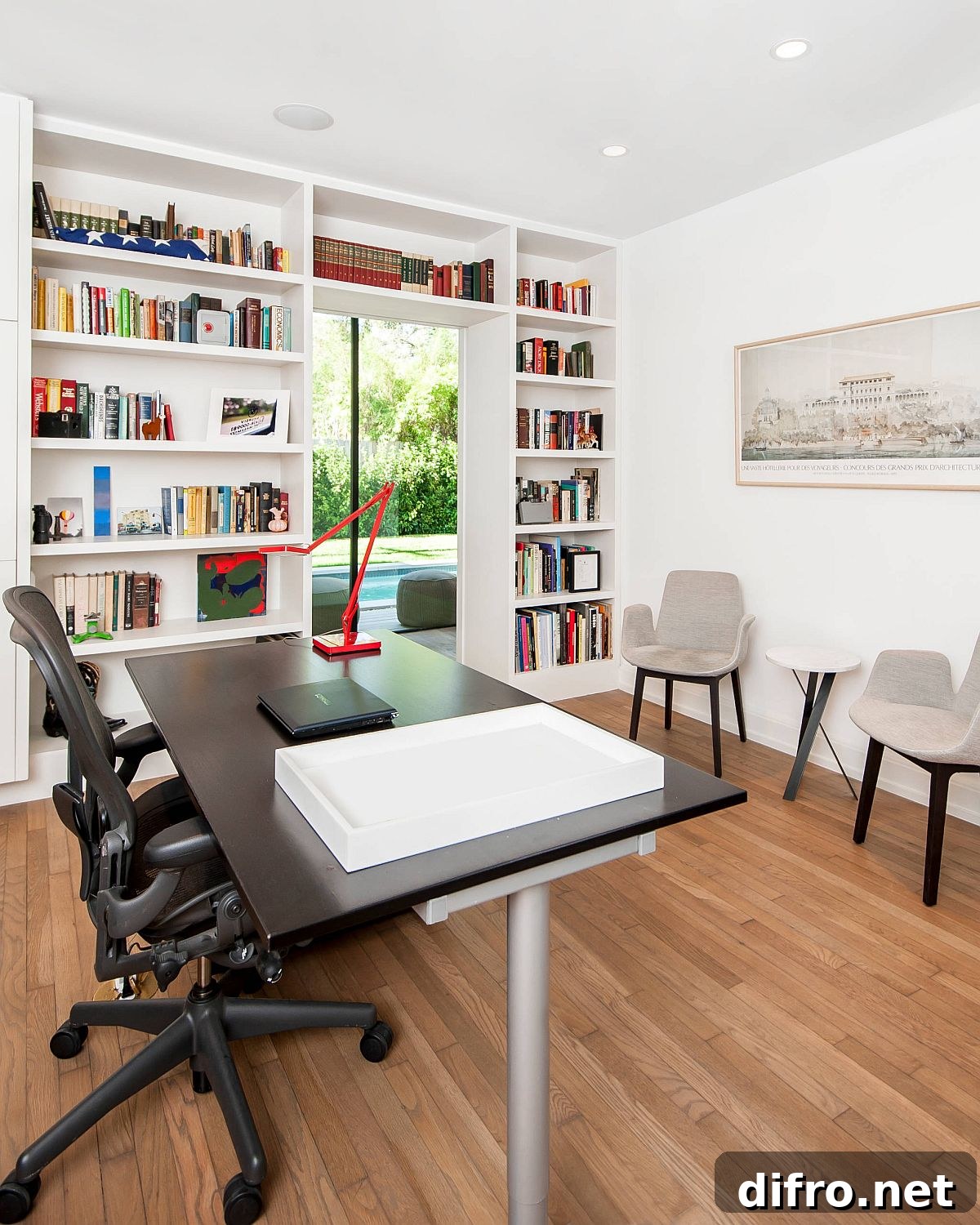White and wood home office with bookshelf wrapped around the doorway