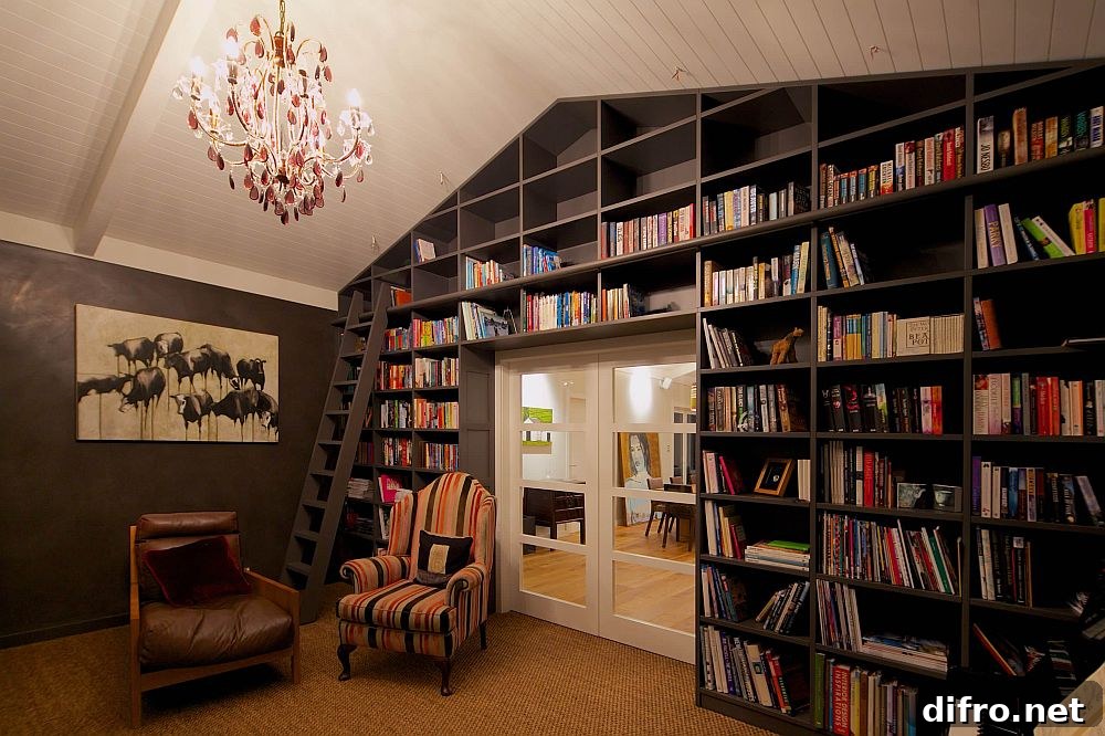 Living room with vaulted ceiling and black bookshelves