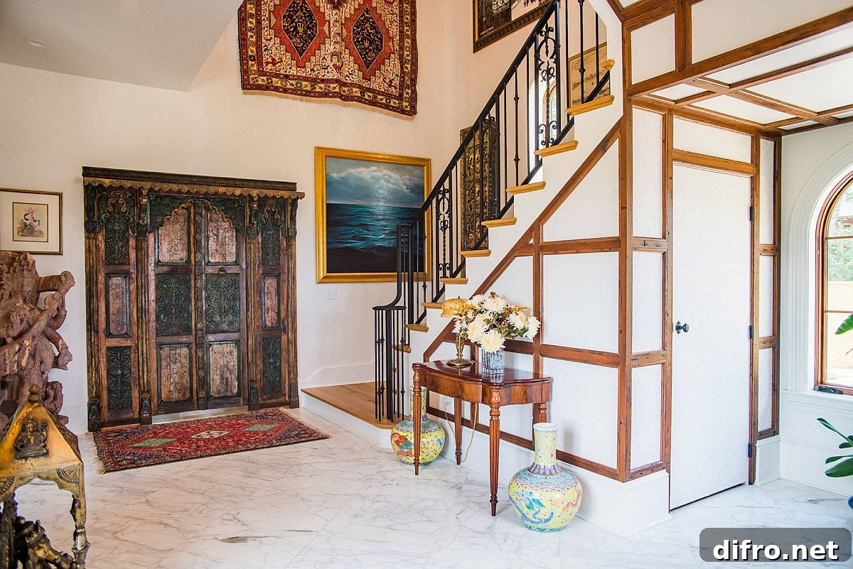 Eclectic entry with exotic decor and white marble floor