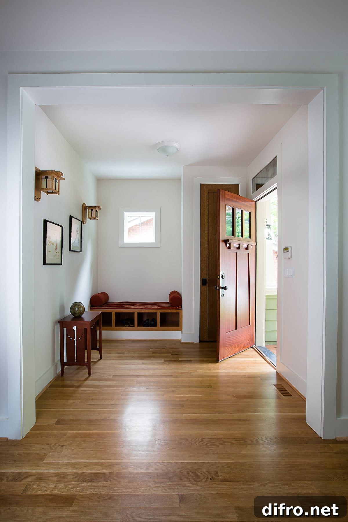 Compact entry in white with wooden storage and decor