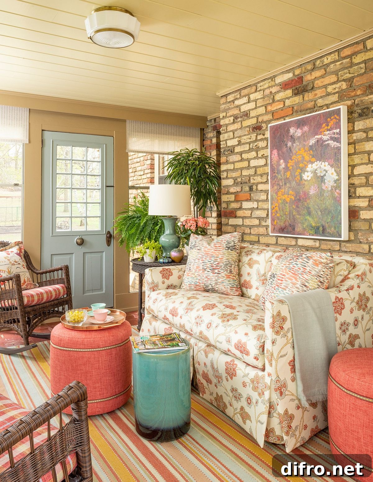 Colorful couch, pink stools, and accent brick wall