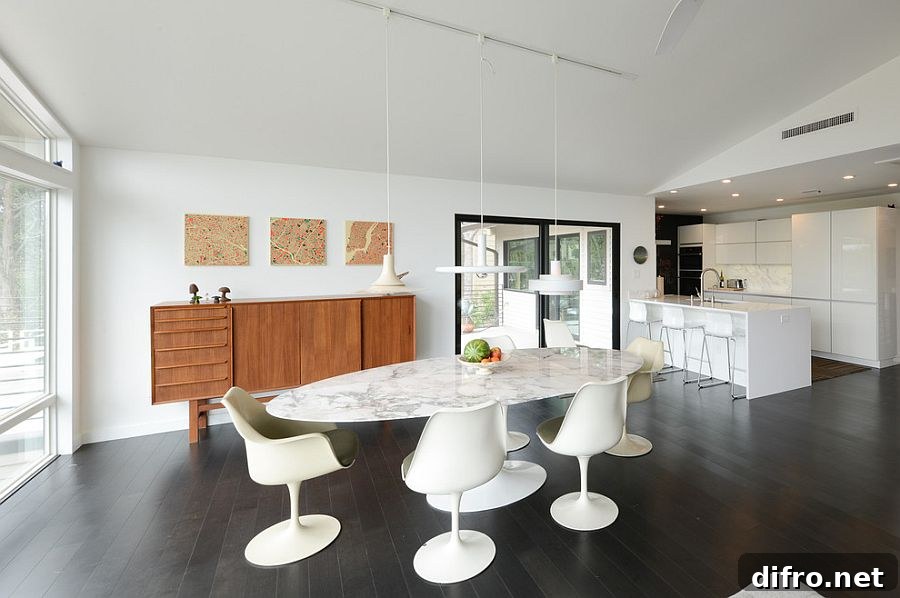 Oval shaped dining table in marble with pendants in white above