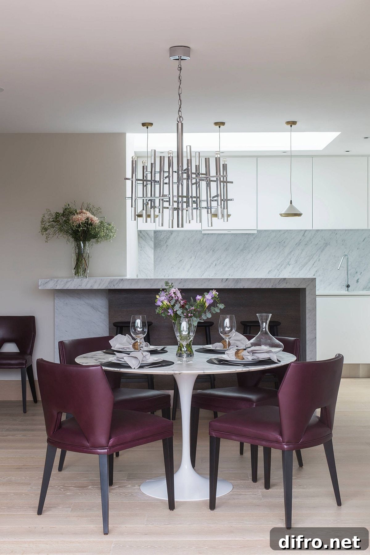 Purple chairs paired with a white marble dining table with pedestal base
