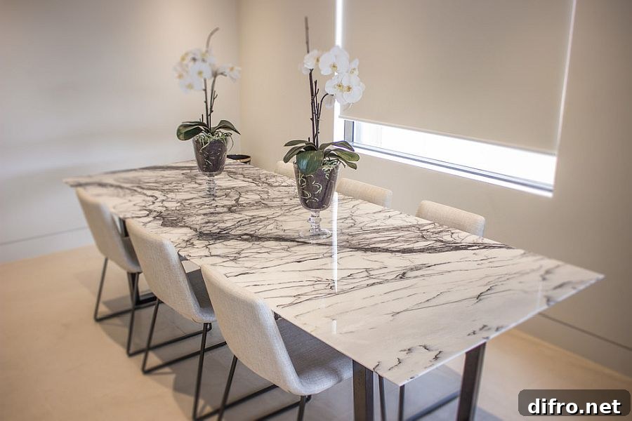 Marble top dining table in an all-white contemporary dining room