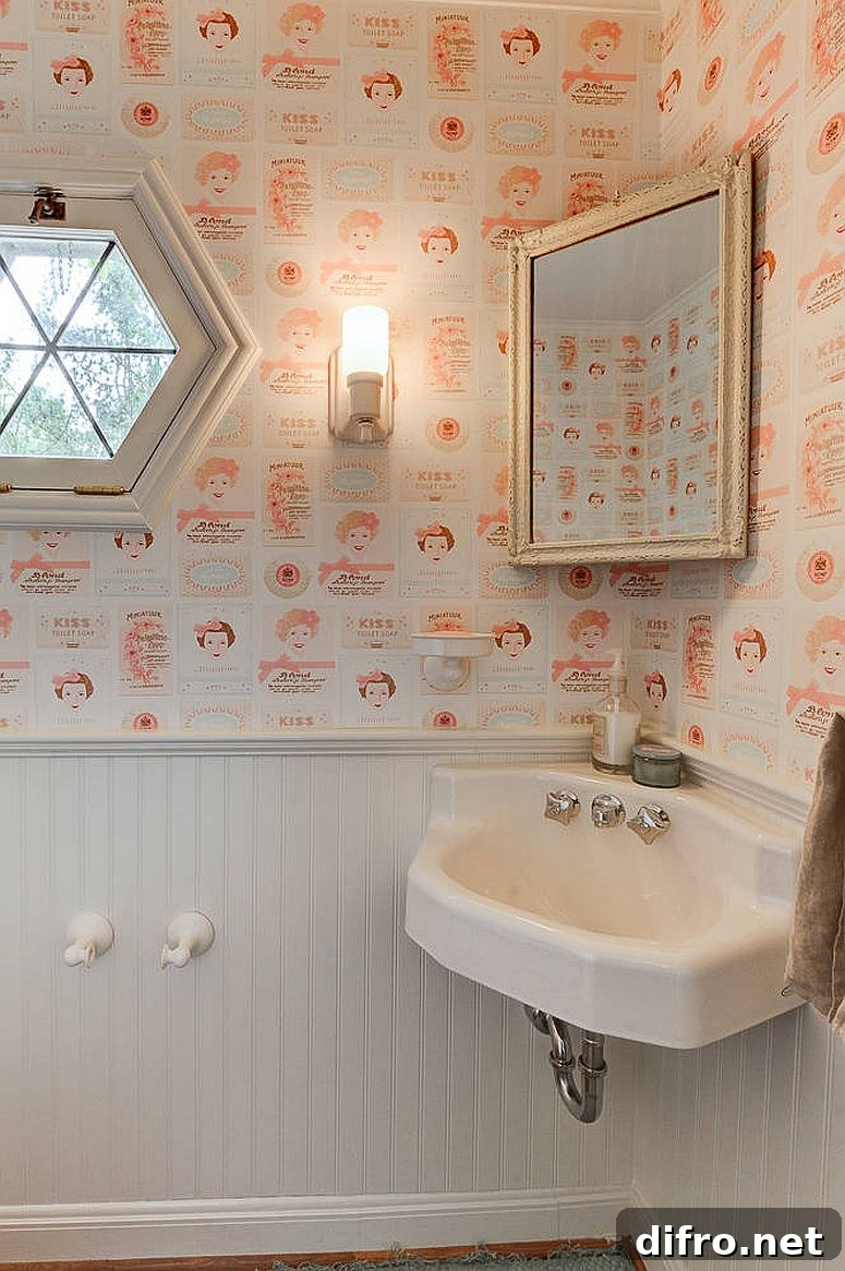 Wallpaper that steals the show in a white powder room