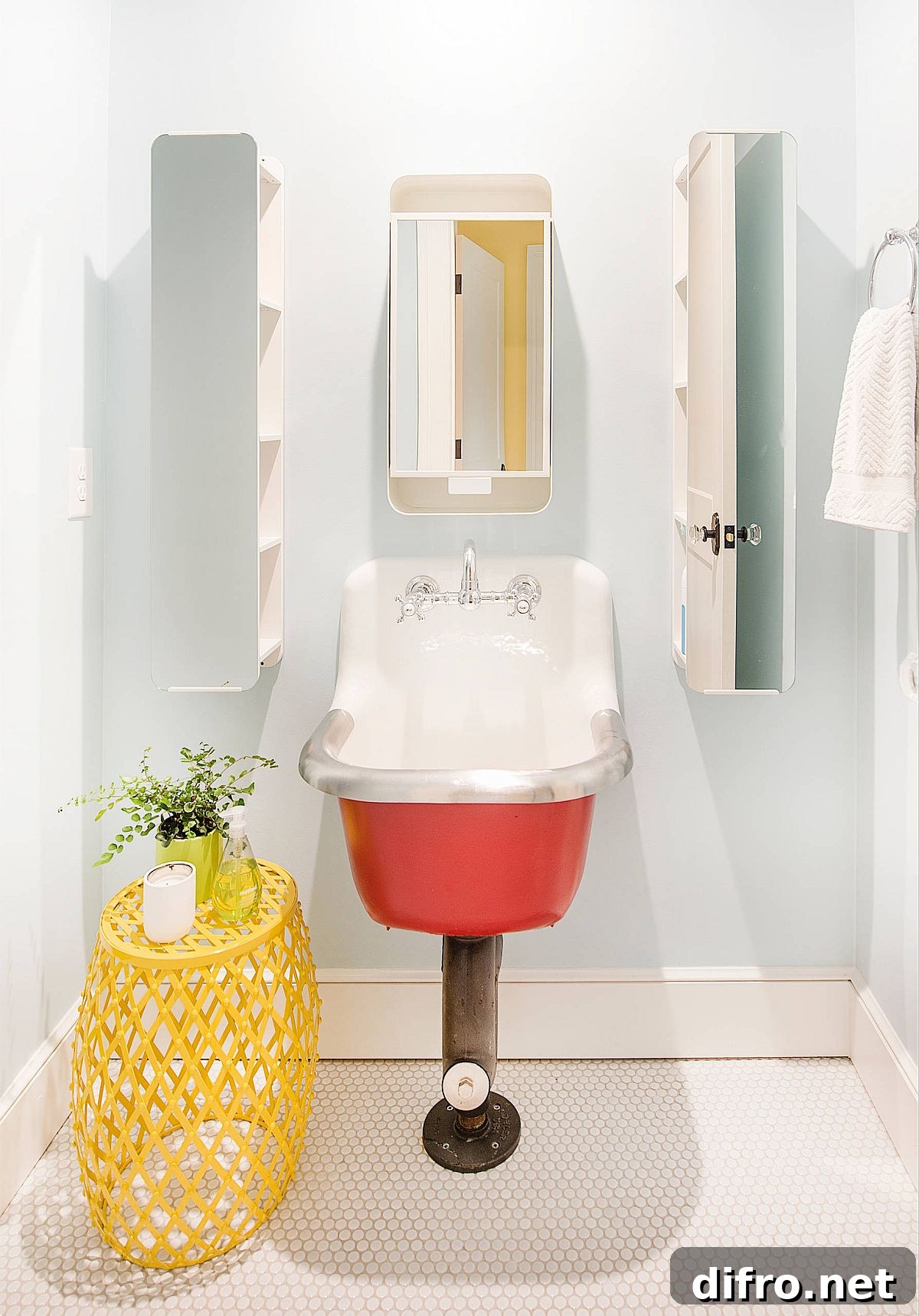 Modern farmhouse powder room with bright pops of color and a unique sink