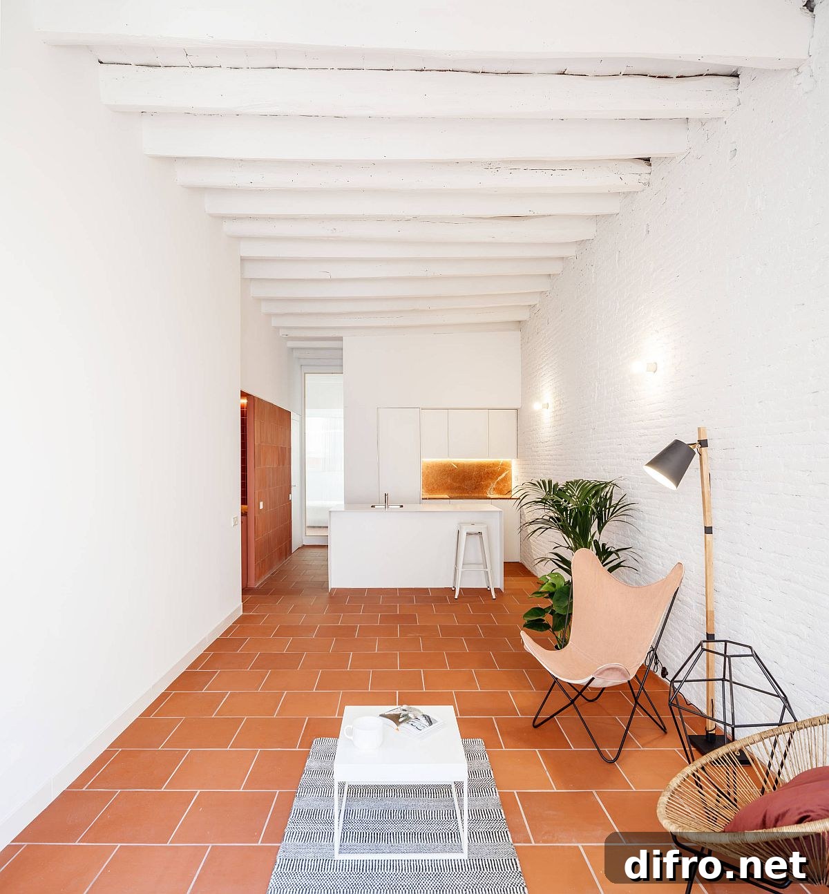 Modern living room with white brick walls and terracotta tile floor