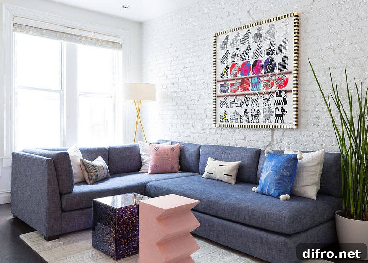 Bluish-gray sectional in white living room with painted brick wall