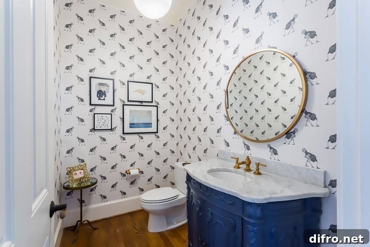 Powder room with patterned wallpaper and blue vanity