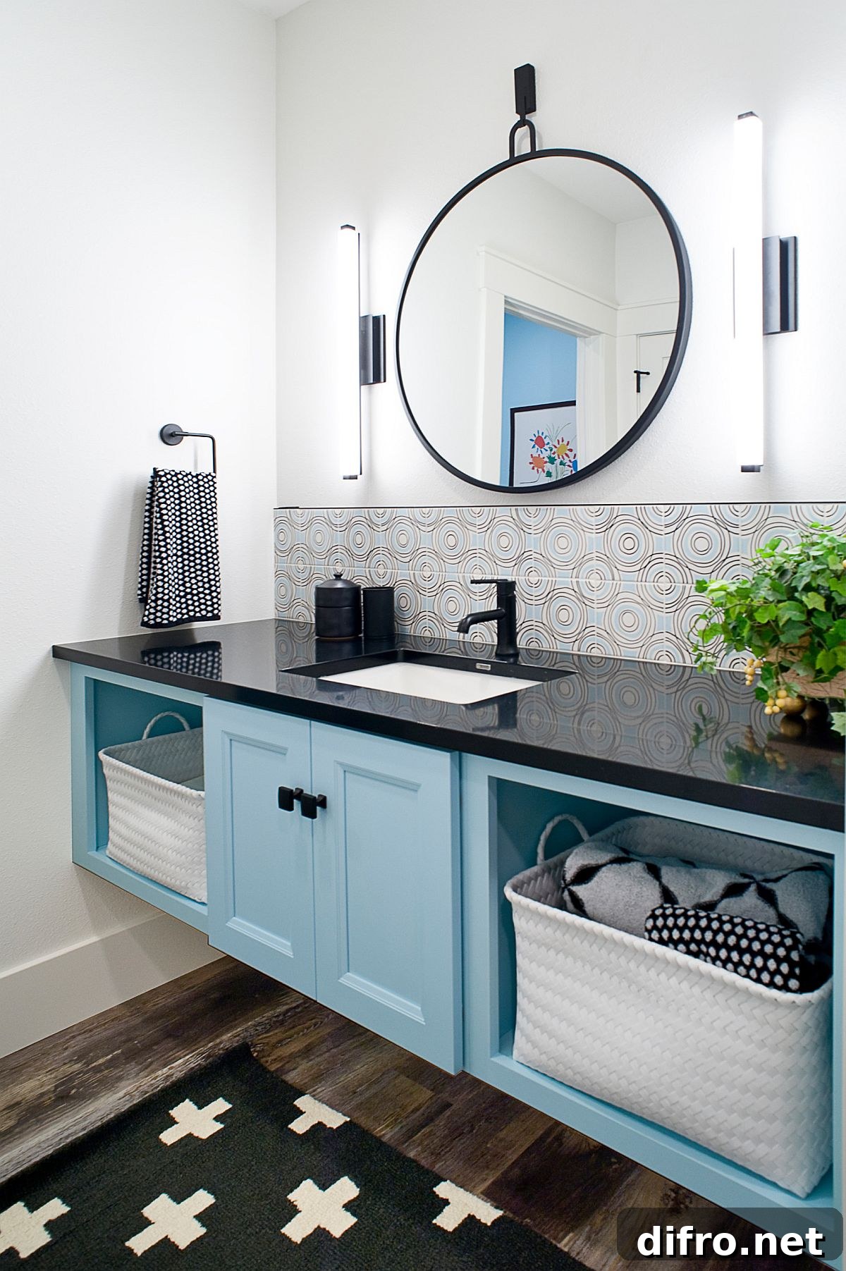 Light blue vanity with open shelving and black countertop