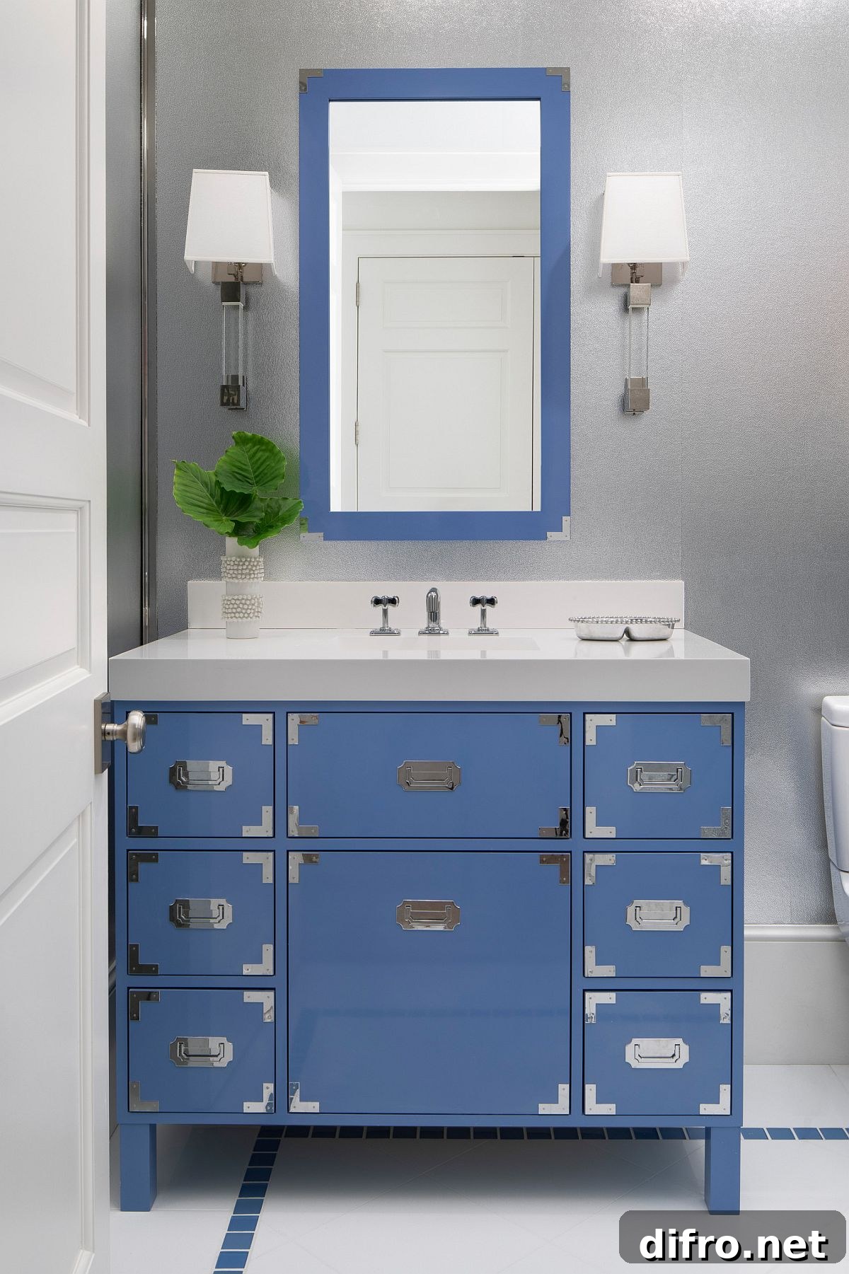 Chic powder room with blue vanity and matching mirror frame