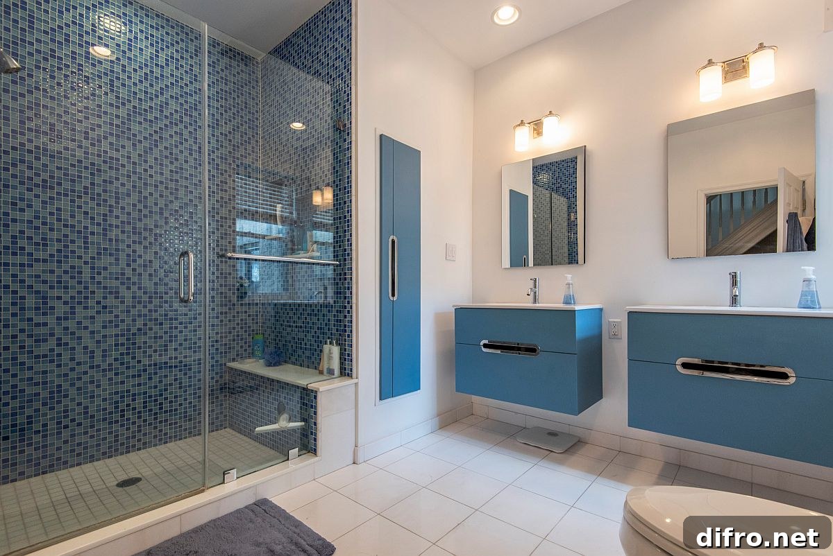 Double blue vanities in a spacious white bathroom