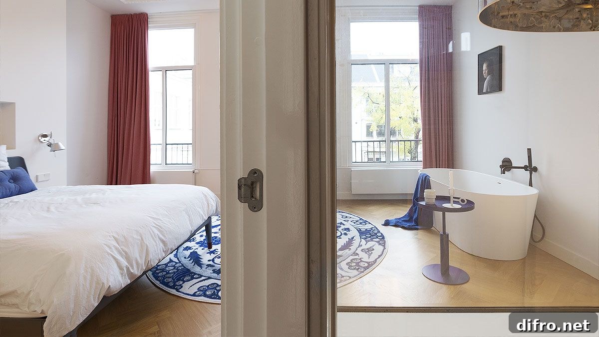 Luxurious master bedroom and bathroom with traditional style and a blue and white color scheme