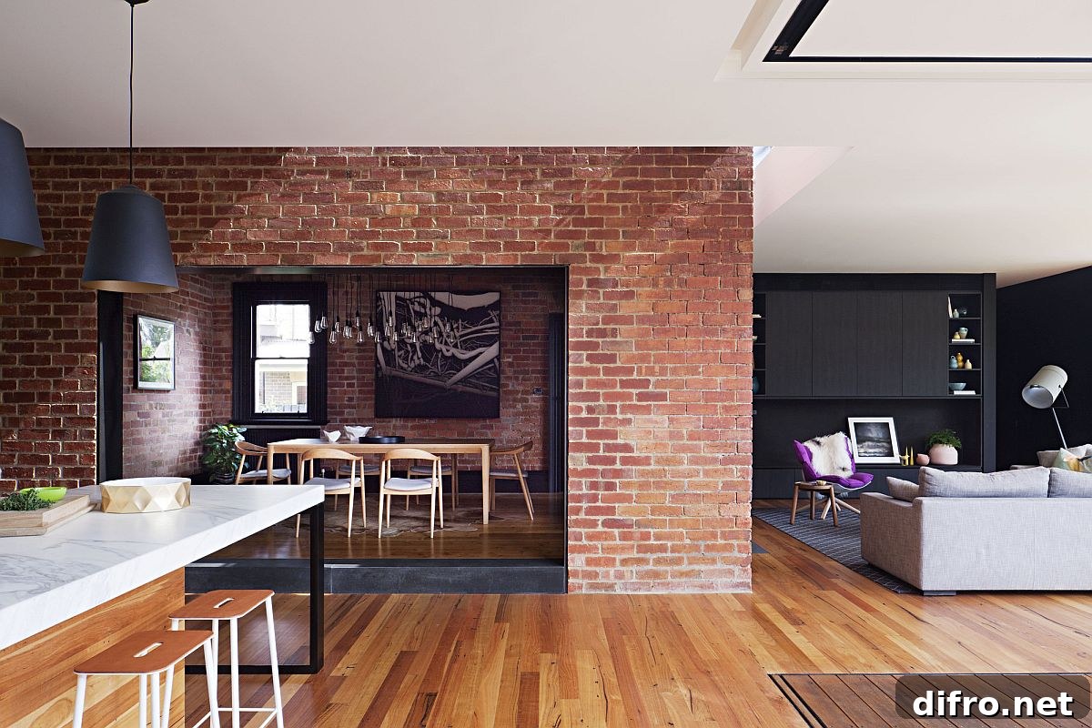 Brick wall sections coupled with wooden flooring inside the heritage Aussie home