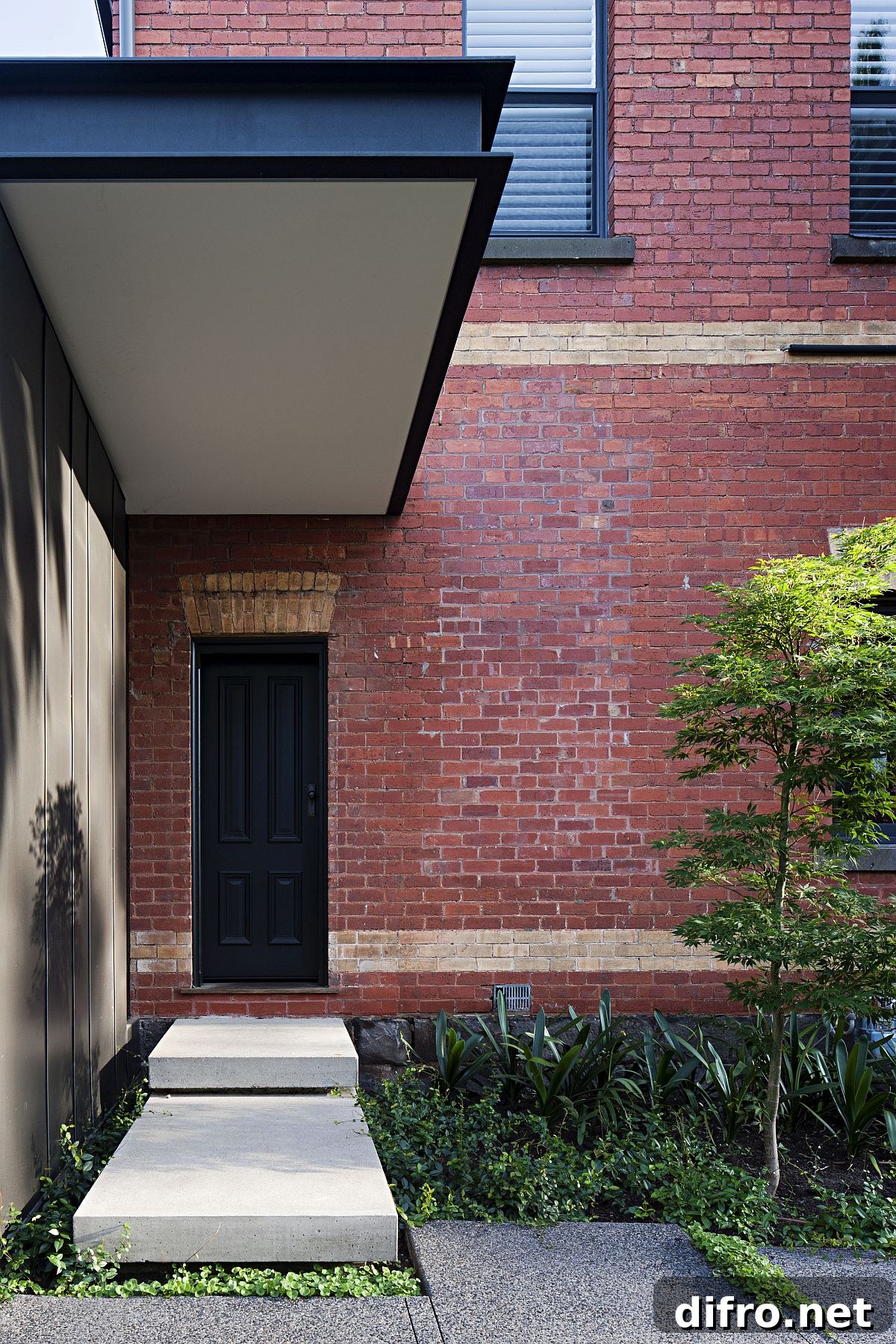 Sheltered street facade of the Melbourne home with brick walls