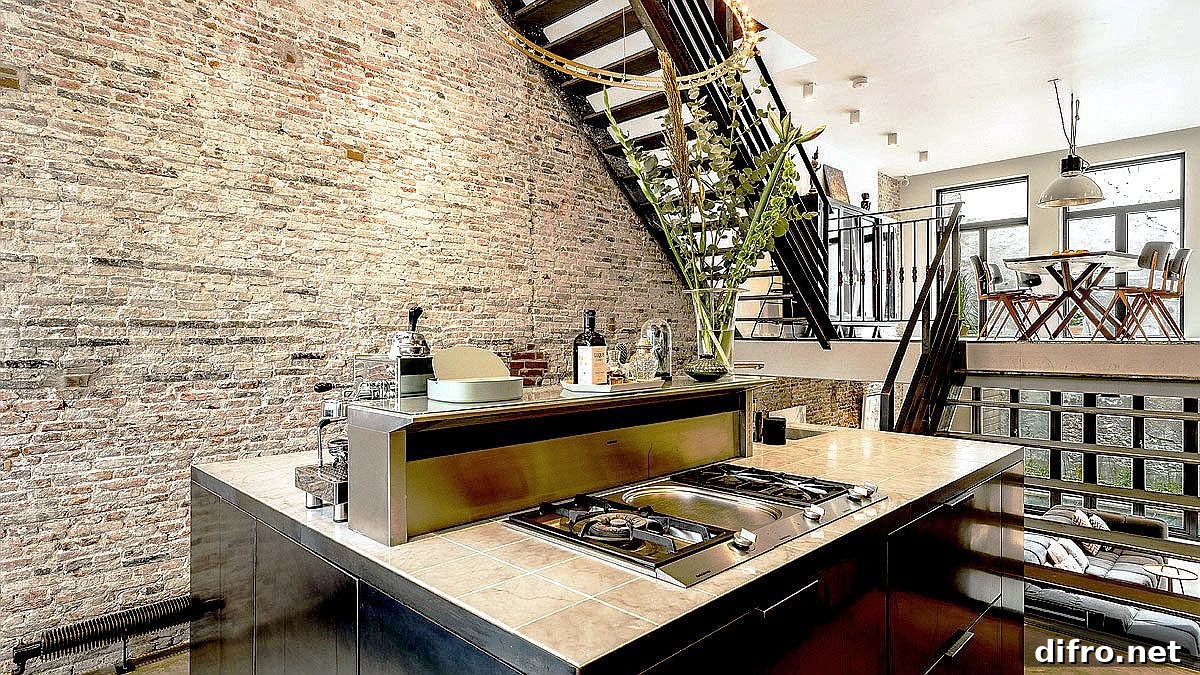 Metal staircase connecting split-level living area, kitchen and dining space