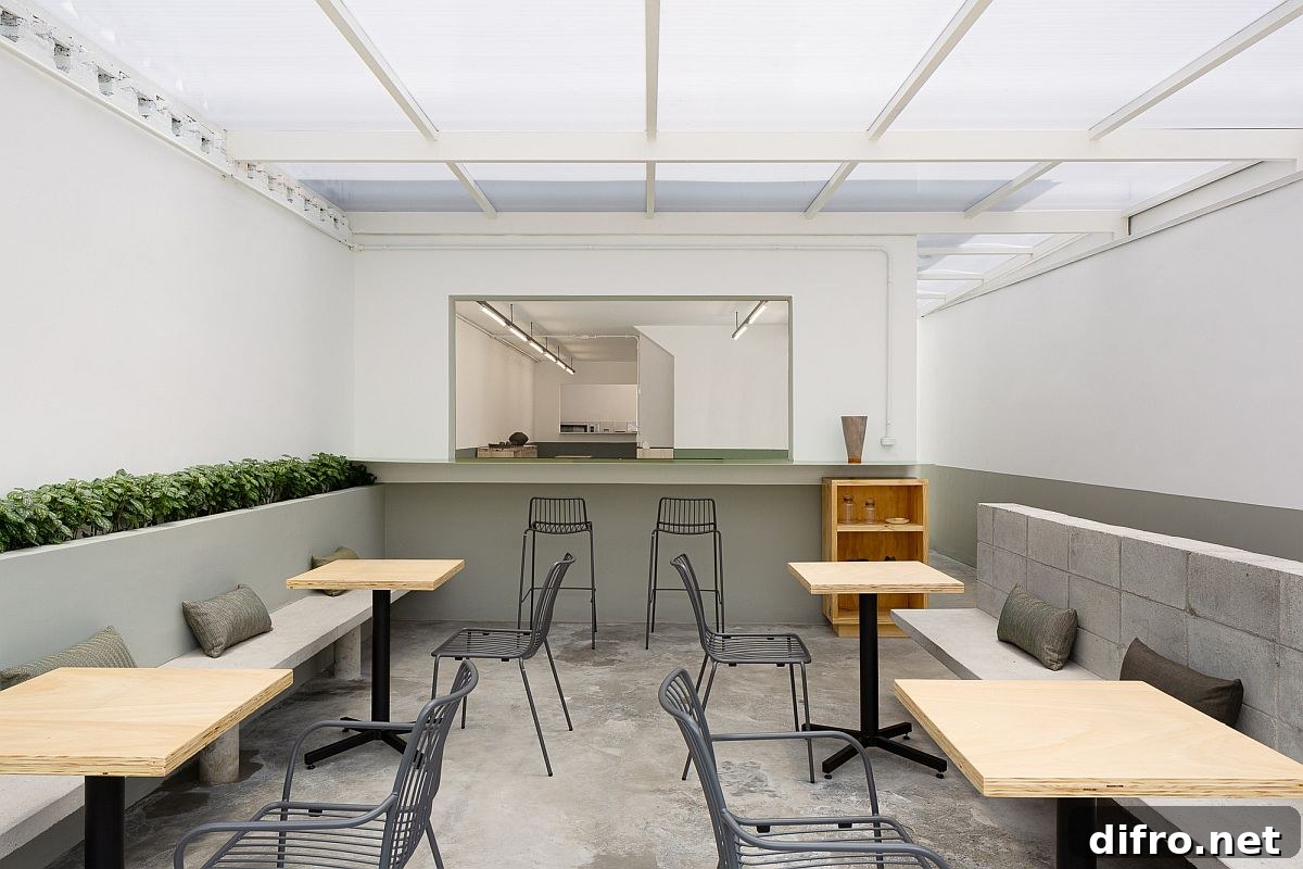 Interior with gray, white, and green accents paired with concrete surfaces