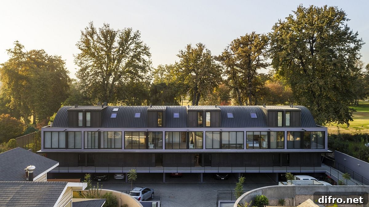 Modern townhouses in metal and glass with a golf course in the backdrop