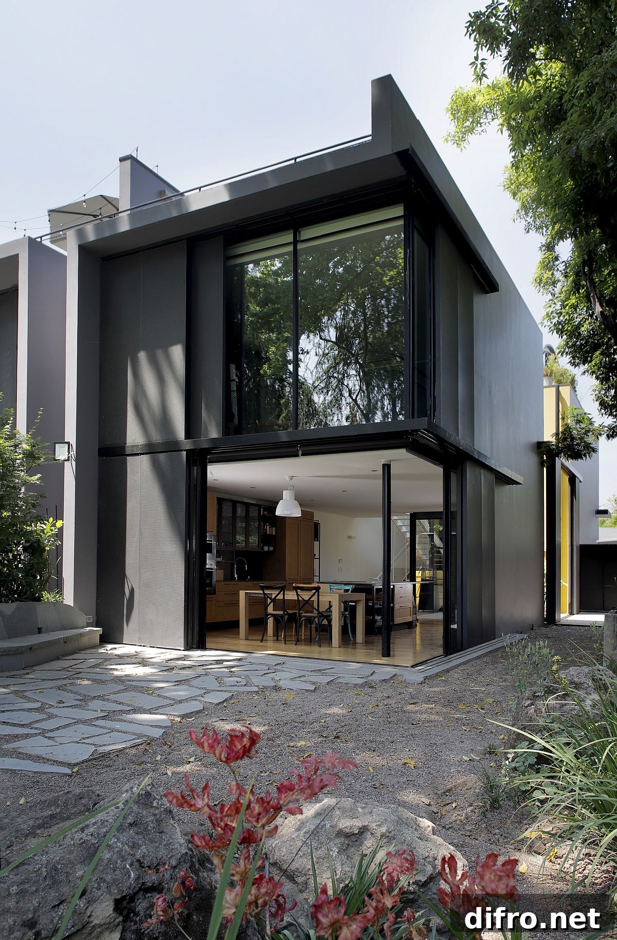 Sliding doors open up the kitchen and dining space and connect it to the patio outside