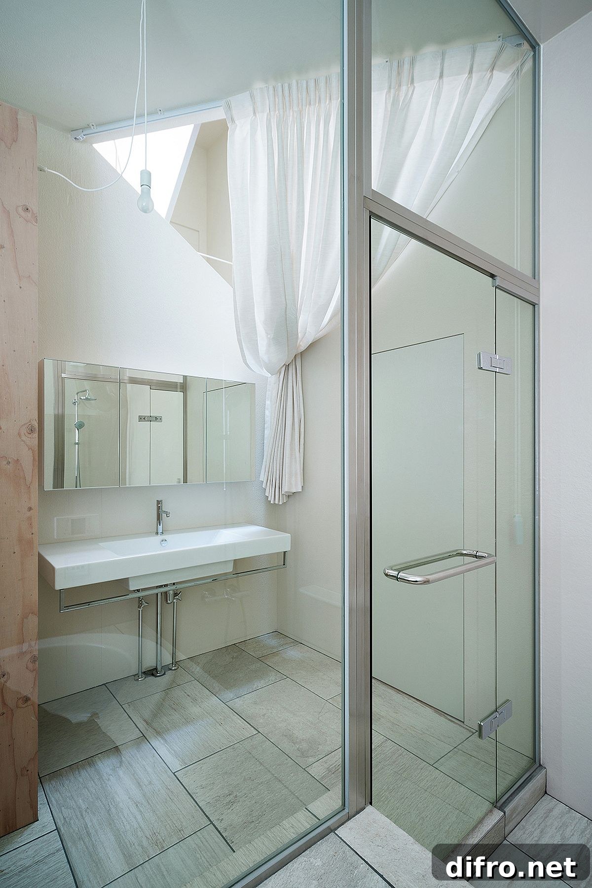 Triangular ceiling cut-out brings daylight into a bathroom