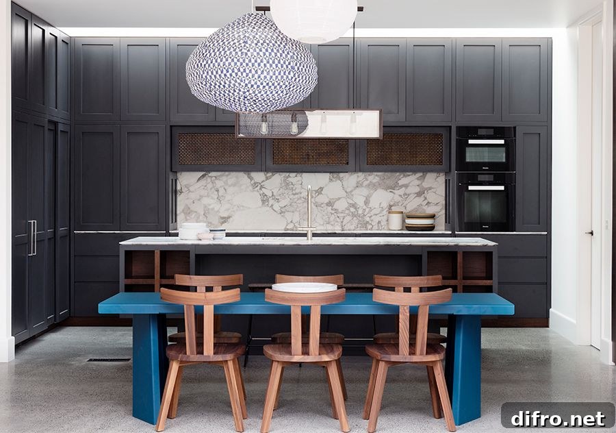 Dining table brings gorgeous blue to the black and white modern kitchen of the Aussie home