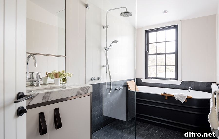 Modern bathroom in black and white with marble finishes and a dashing bathtub