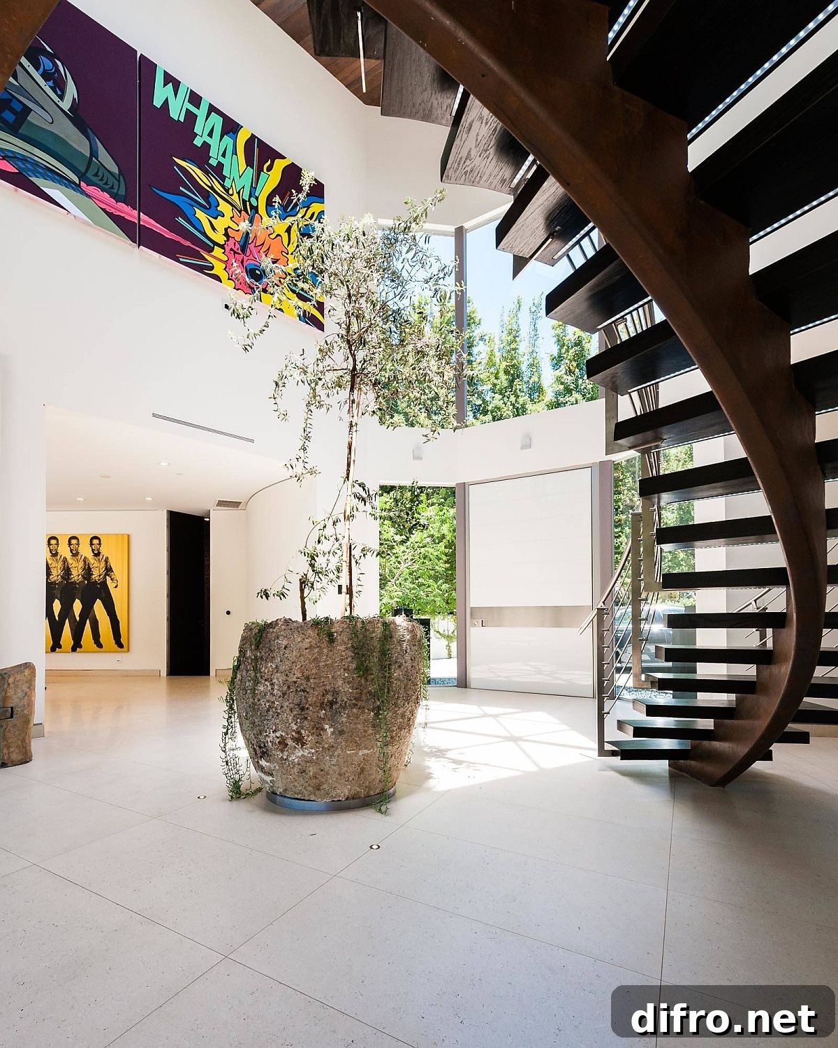 Indoor plant and spiral staircase in modern entry