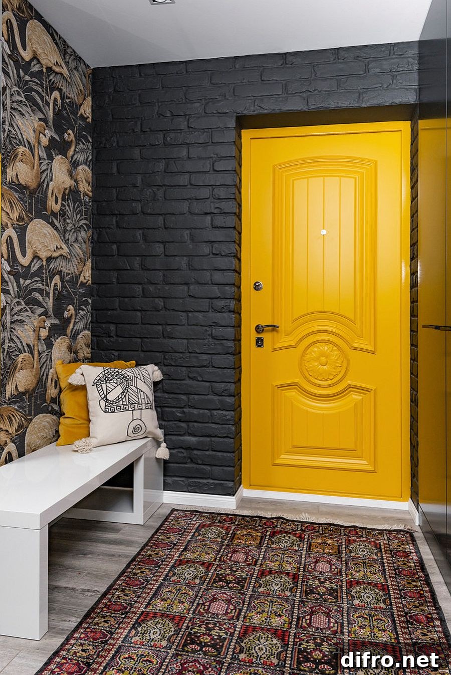 Yellow door in dark contemporary entry