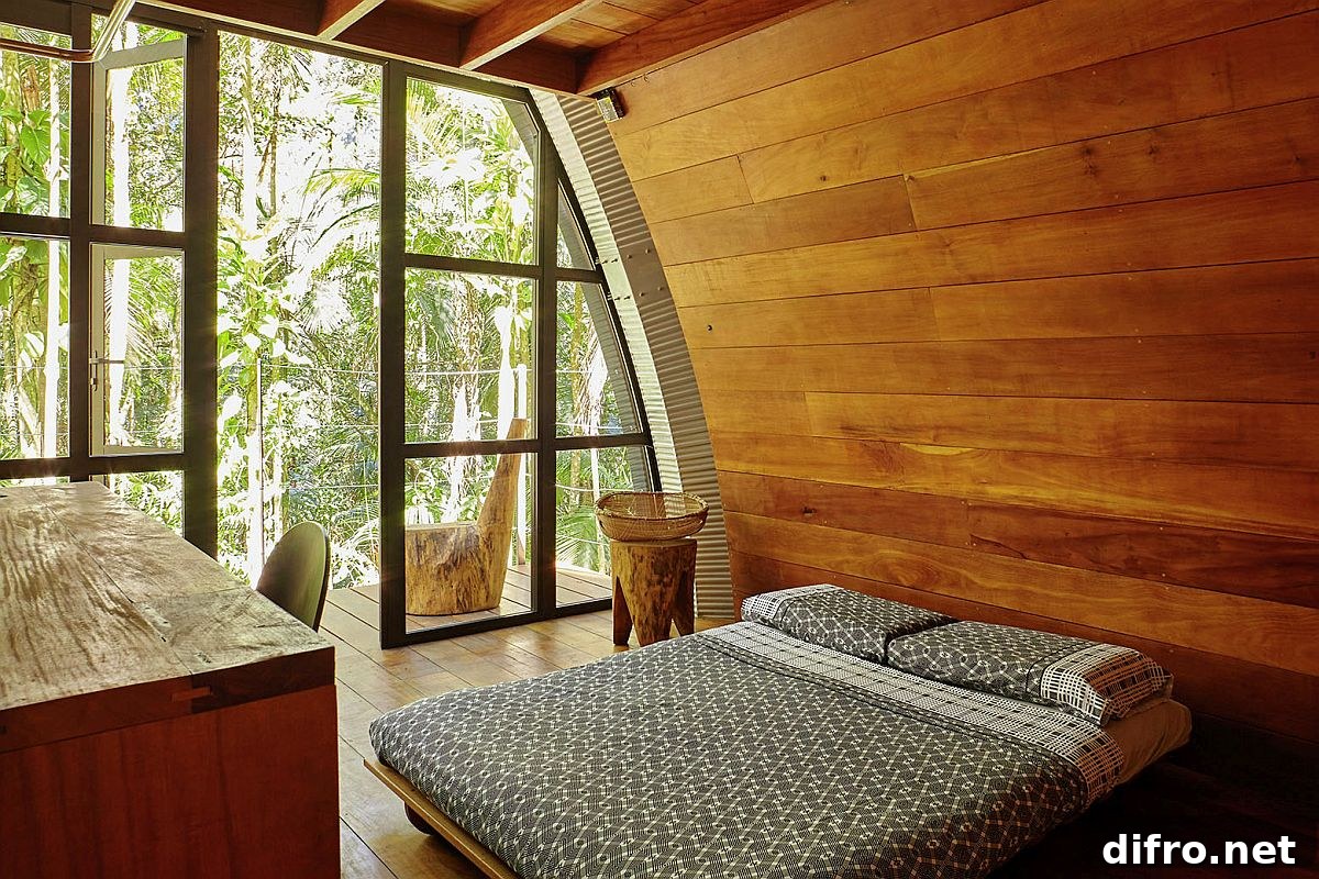 Charming minimal bedroom of the house with wooden walls and curved windows