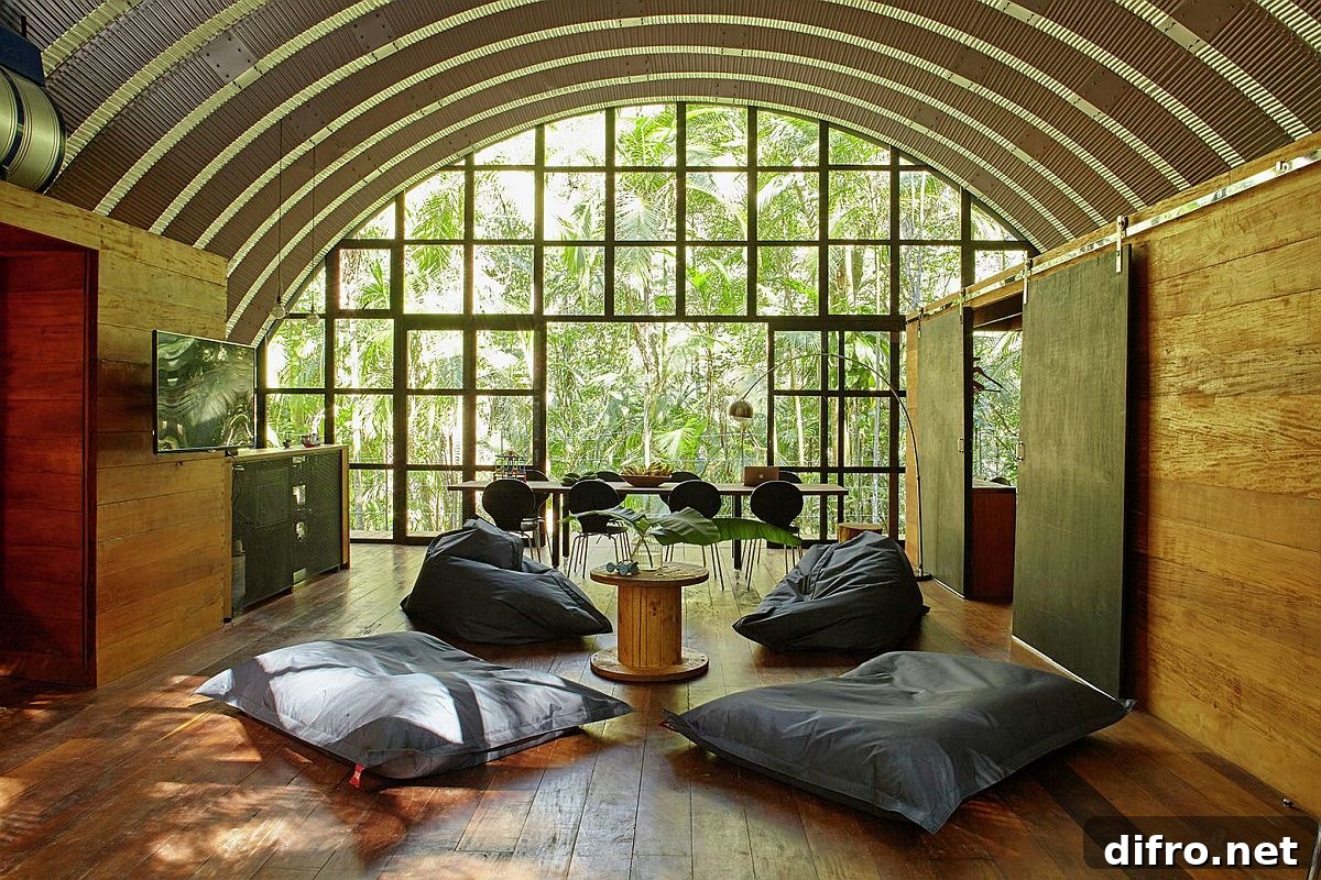 Large walls of glass and windows bring natural light into the spacious, woodsy living room