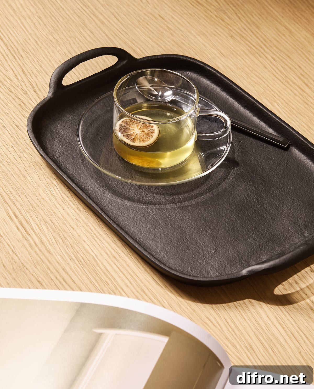 Metal tray with a cup of tea on a side table