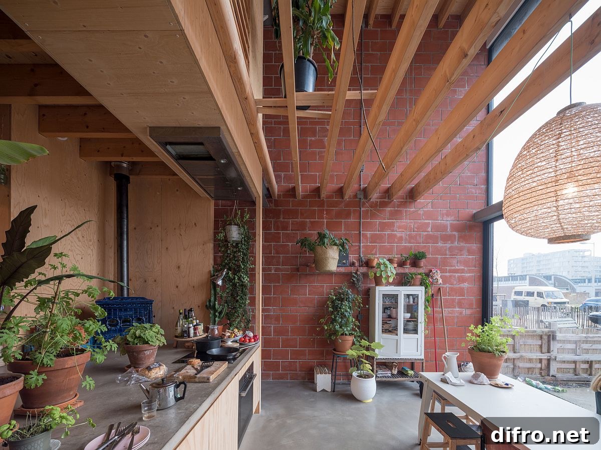 Pleasing blend of warm red terracotta bricks and wood in the kitchen with a metal door that can be lifted up