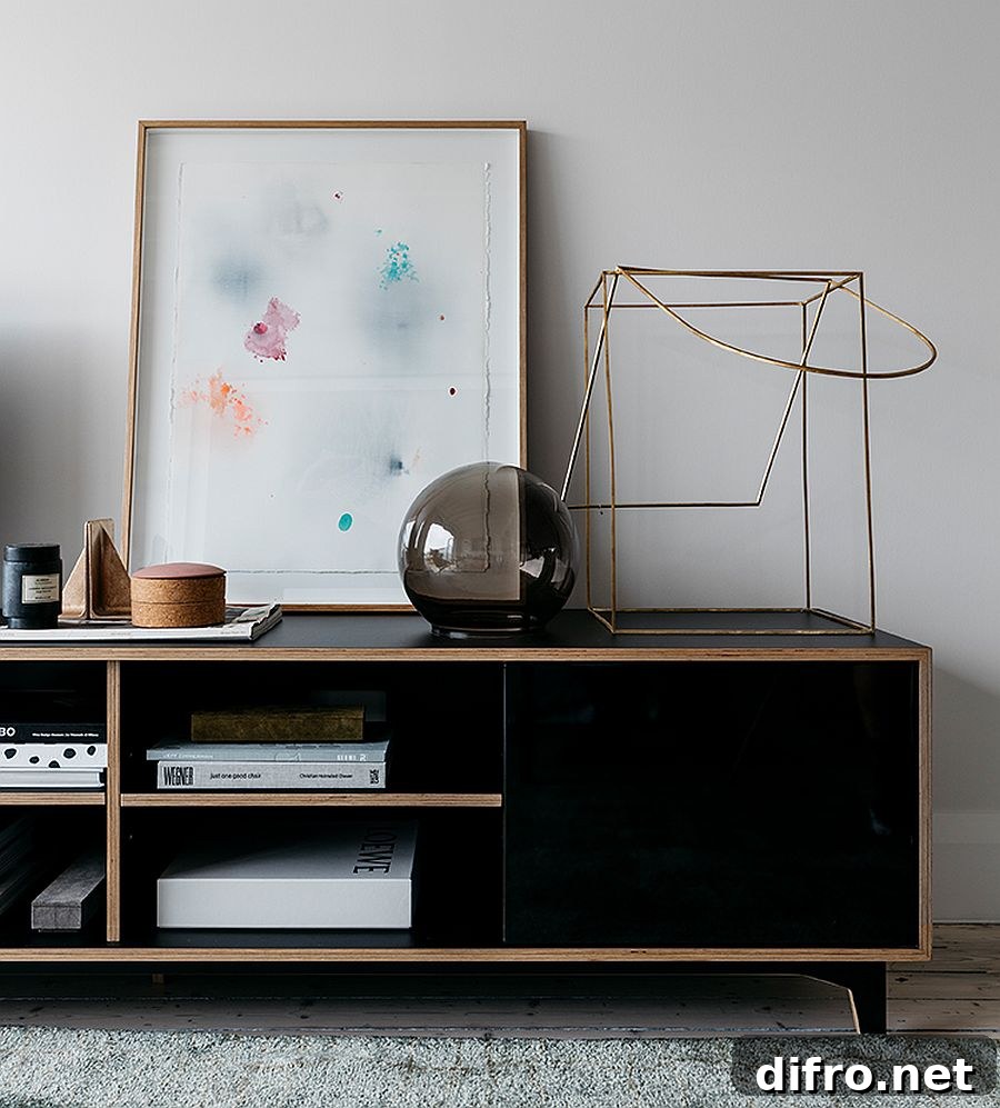 Black wooden credenza styled with sculptural pieces